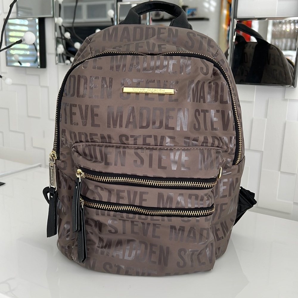 Brown Steve Madden Backpack with black straps and gold accents